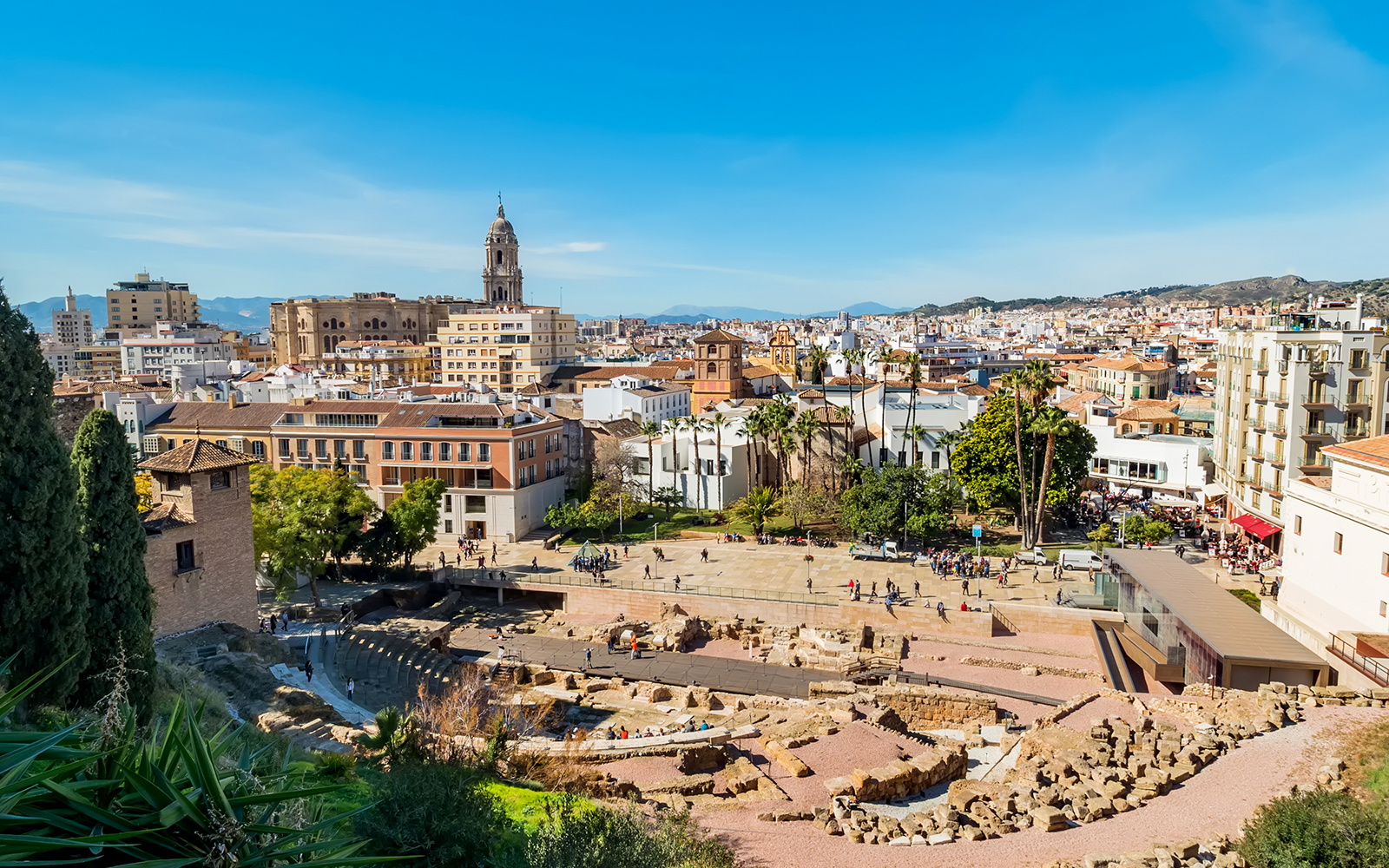 Roman Theatre ruins with Malaga cityscape near Picasso Museum.