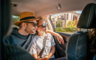 Tourists in a car enjoying a scenic drive, part of Similan Islands tour with hotel transfers.