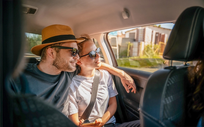 Tourists in a car enjoying a scenic drive, part of Similan Islands tour with hotel transfers.