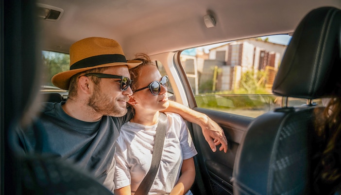 Tourists in a car enjoying a scenic drive, part of Surin Islands tour with hotel transfers.