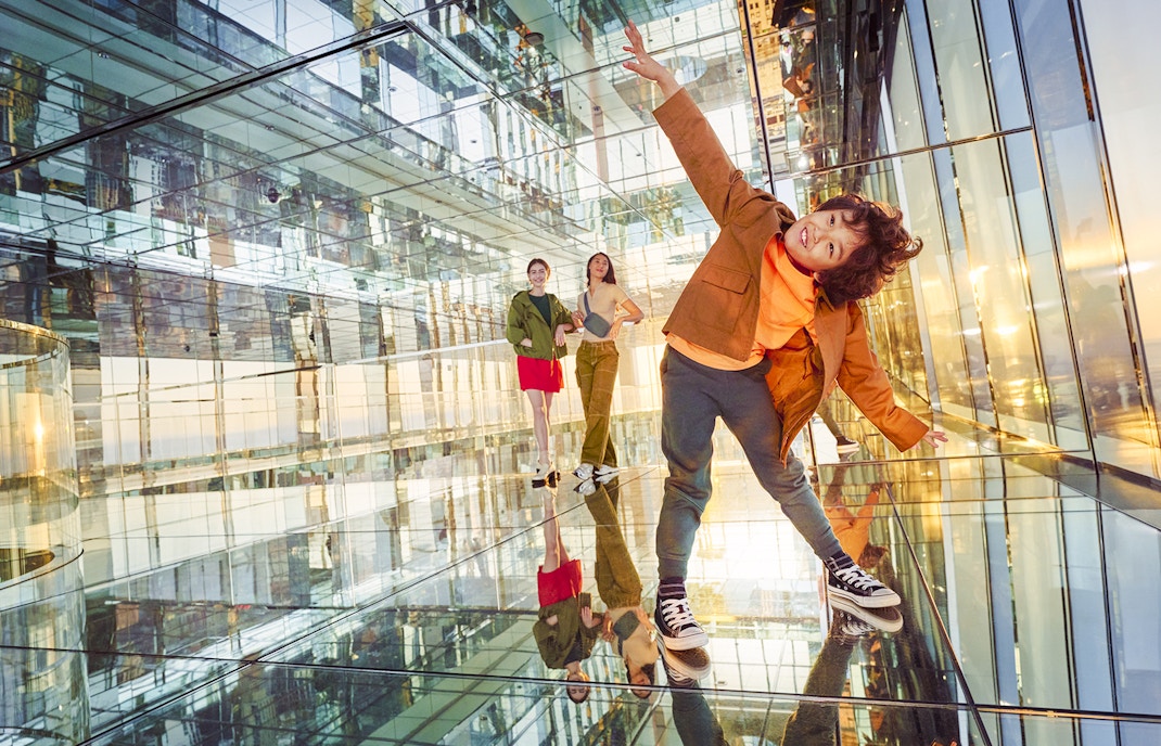 A child posing, enjoying the thrill of the heights at AIR