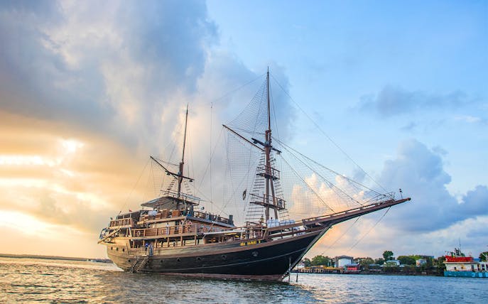Pirate ship sailing at sunset on a dinner cruise.
