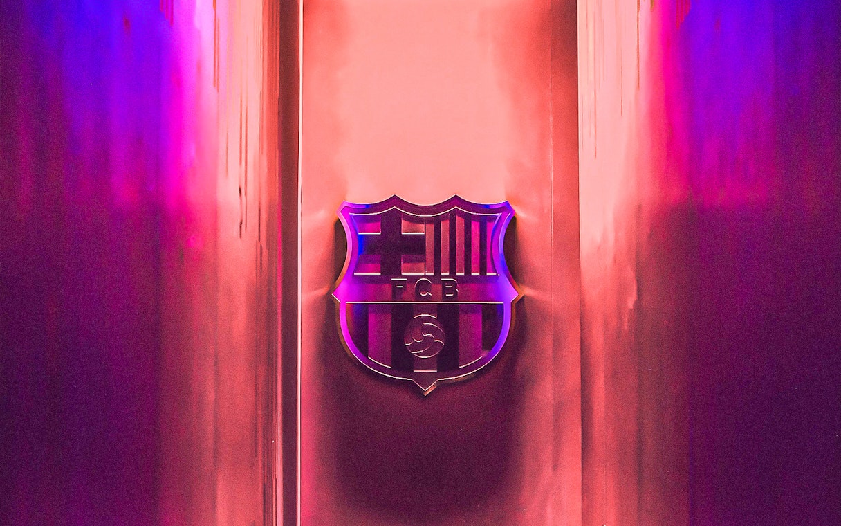 FC Barcelona emblem at Camp Nou stadium entrance.