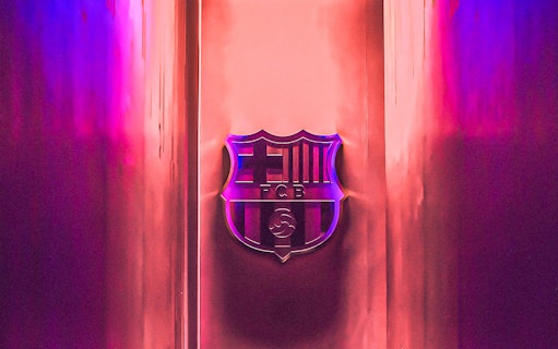 FC Barcelona emblem at Camp Nou stadium entrance.