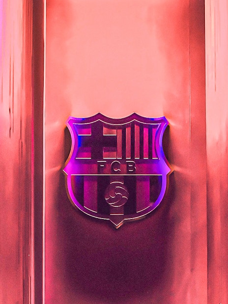 FC Barcelona emblem at Camp Nou stadium entrance.