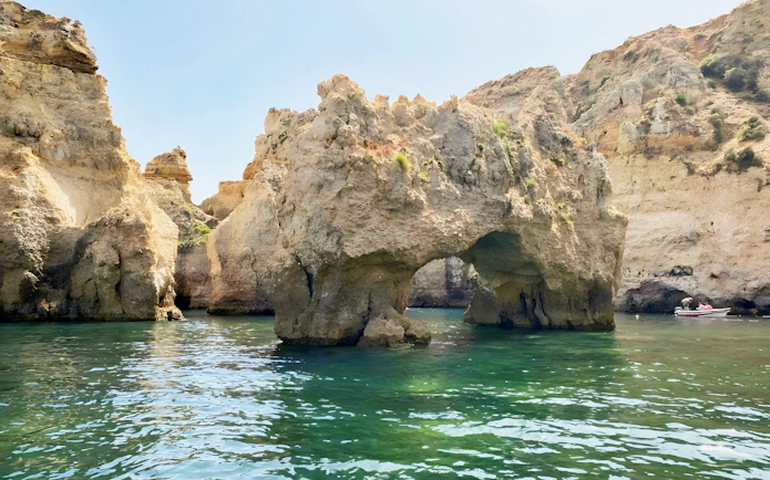 Ponta da Piedade rock formations with a boat on the water, Lagos, Portugal.