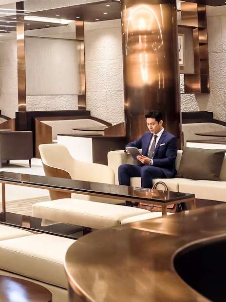 Man seated in Matina Gold lounge, Terminal 2, Incheon International Airport.
