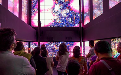 Visitors in Benfica Stadium museum's virtual lift viewing digital display.