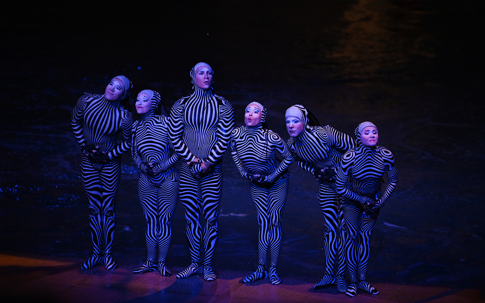 Performers in striped costumes during a theatrical show in Las Vegas.