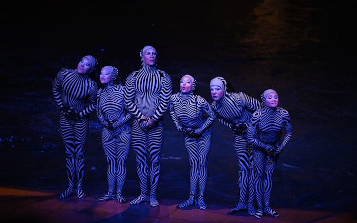 Performers in striped costumes during a theatrical show in Las Vegas.