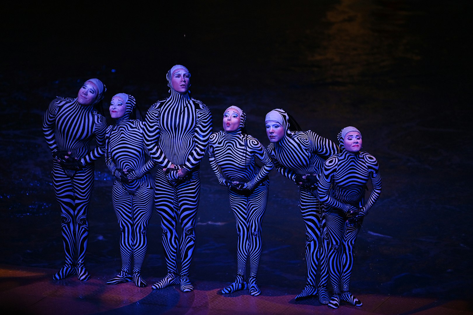 Performers in striped costumes during a theatrical show in Las Vegas.