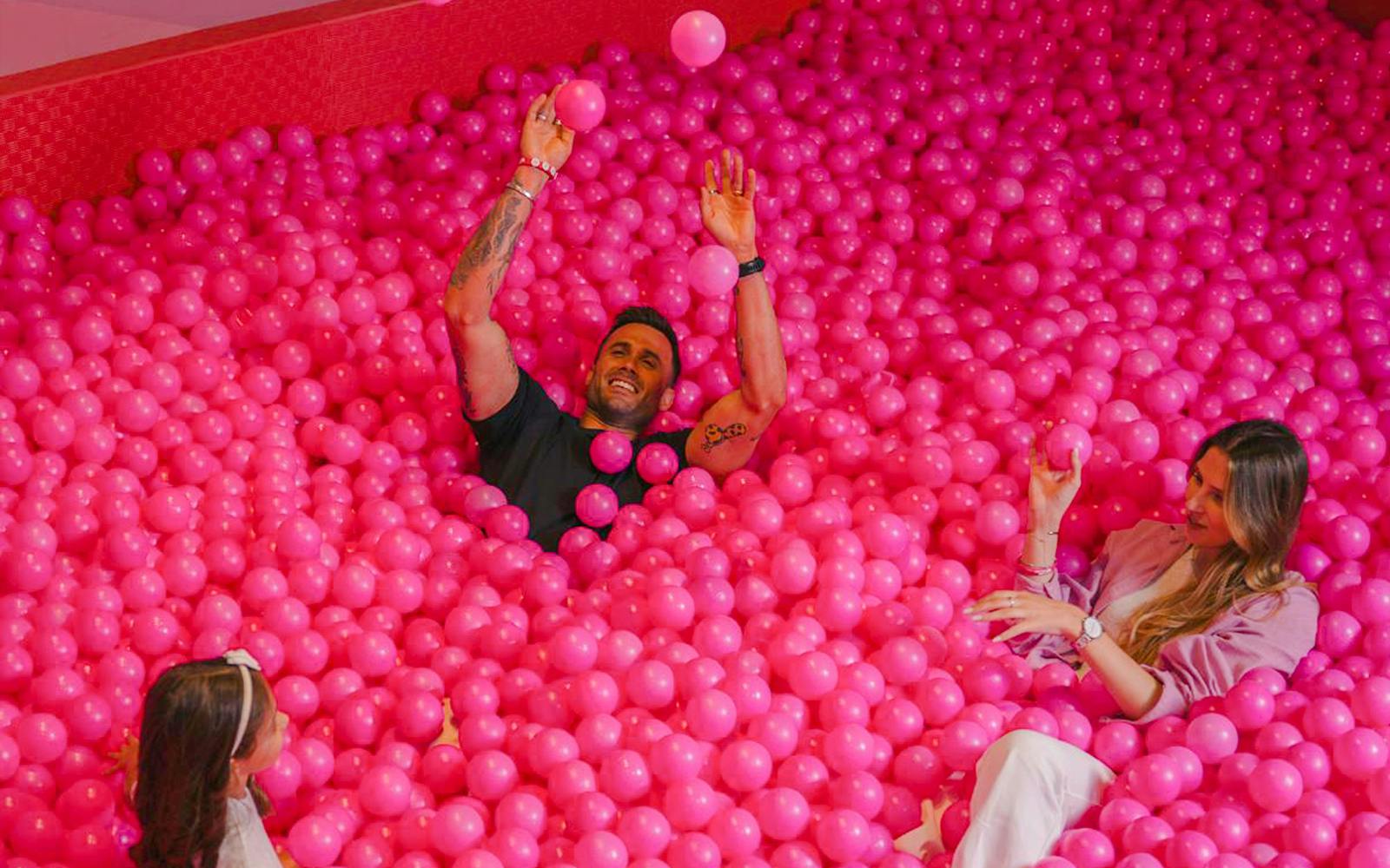 Visitors enjoying a pink ball pit at the Pink Palace in the WOW cultural district.