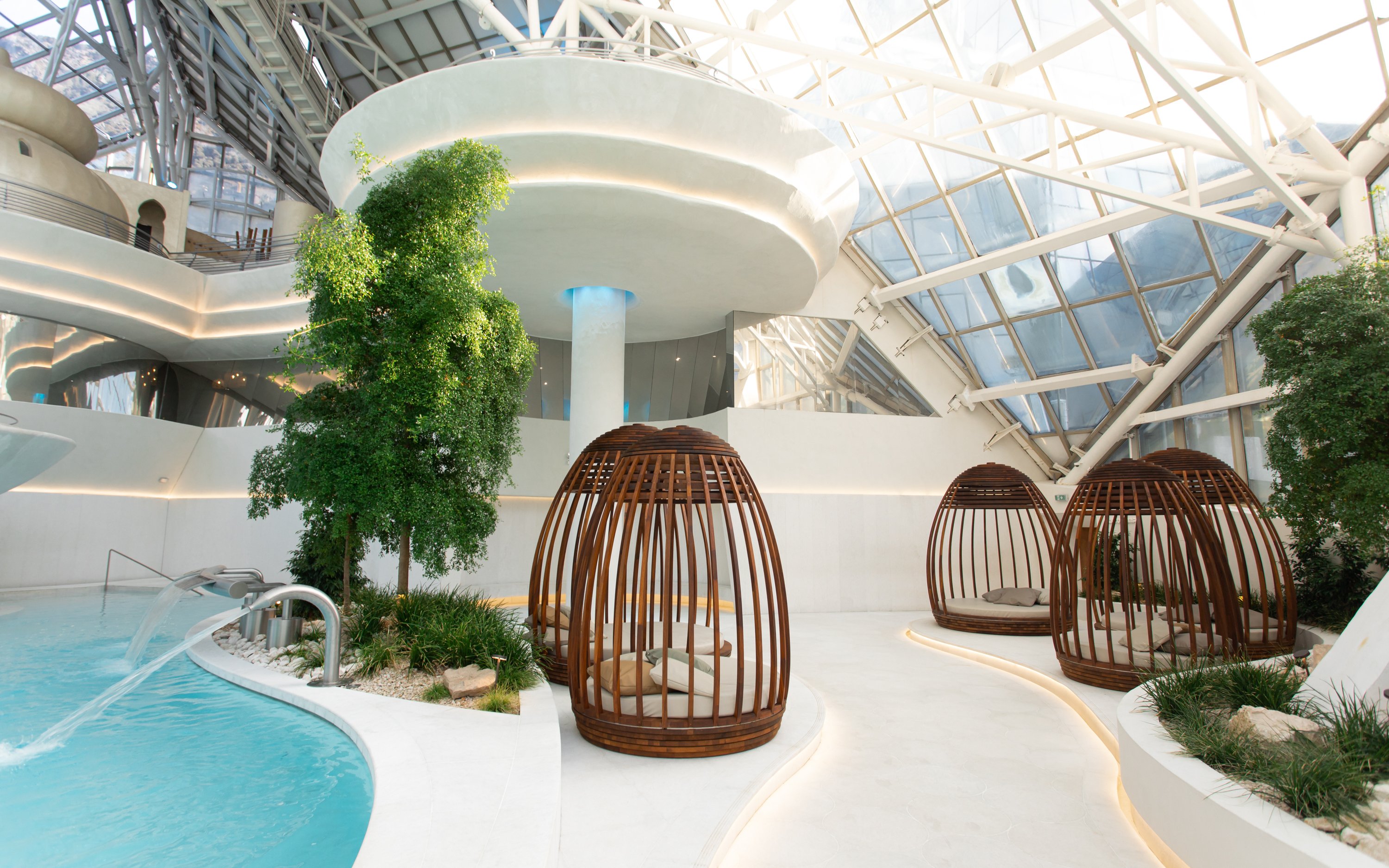 Inuü adults-only area with wooden loungers and pool in Caldea spa, Andorra.