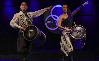 Dancers with drums performing at Michelangelo Tango Show in Buenos Aires.