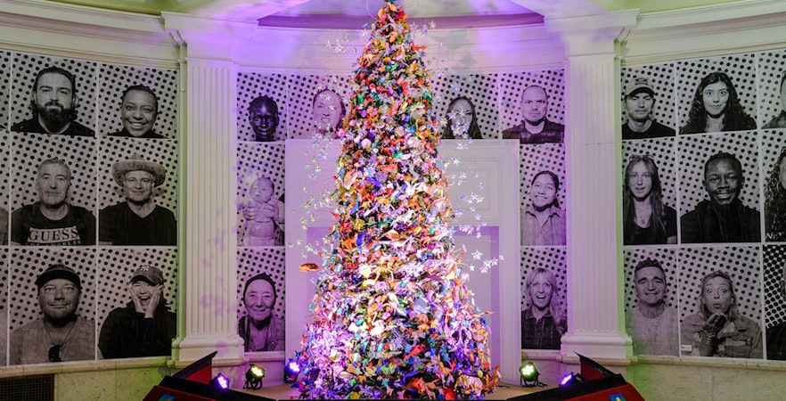 Origami Holiday Tree at American Museum of Natural History adorned with colorful paper figures.