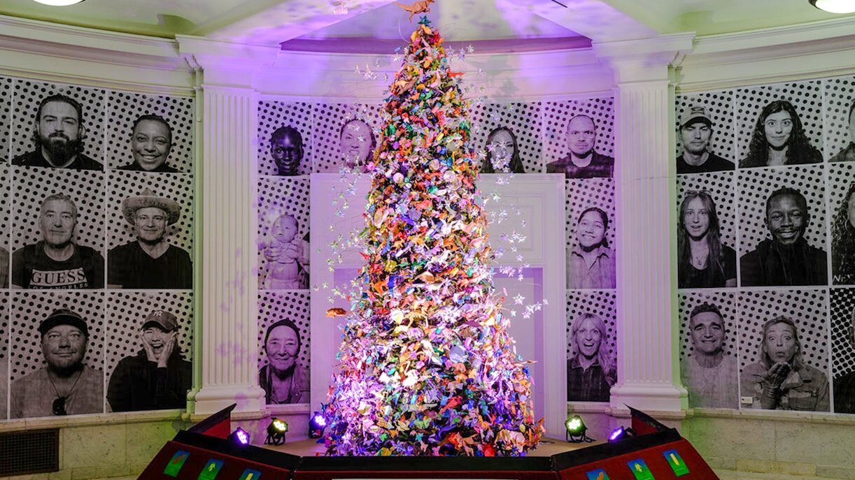 Origami Holiday Tree at American Museum of Natural History adorned with intricate paper designs.