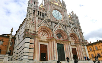 Siena Cathedral facade with intricate Gothic architecture in Tuscany, Italy.