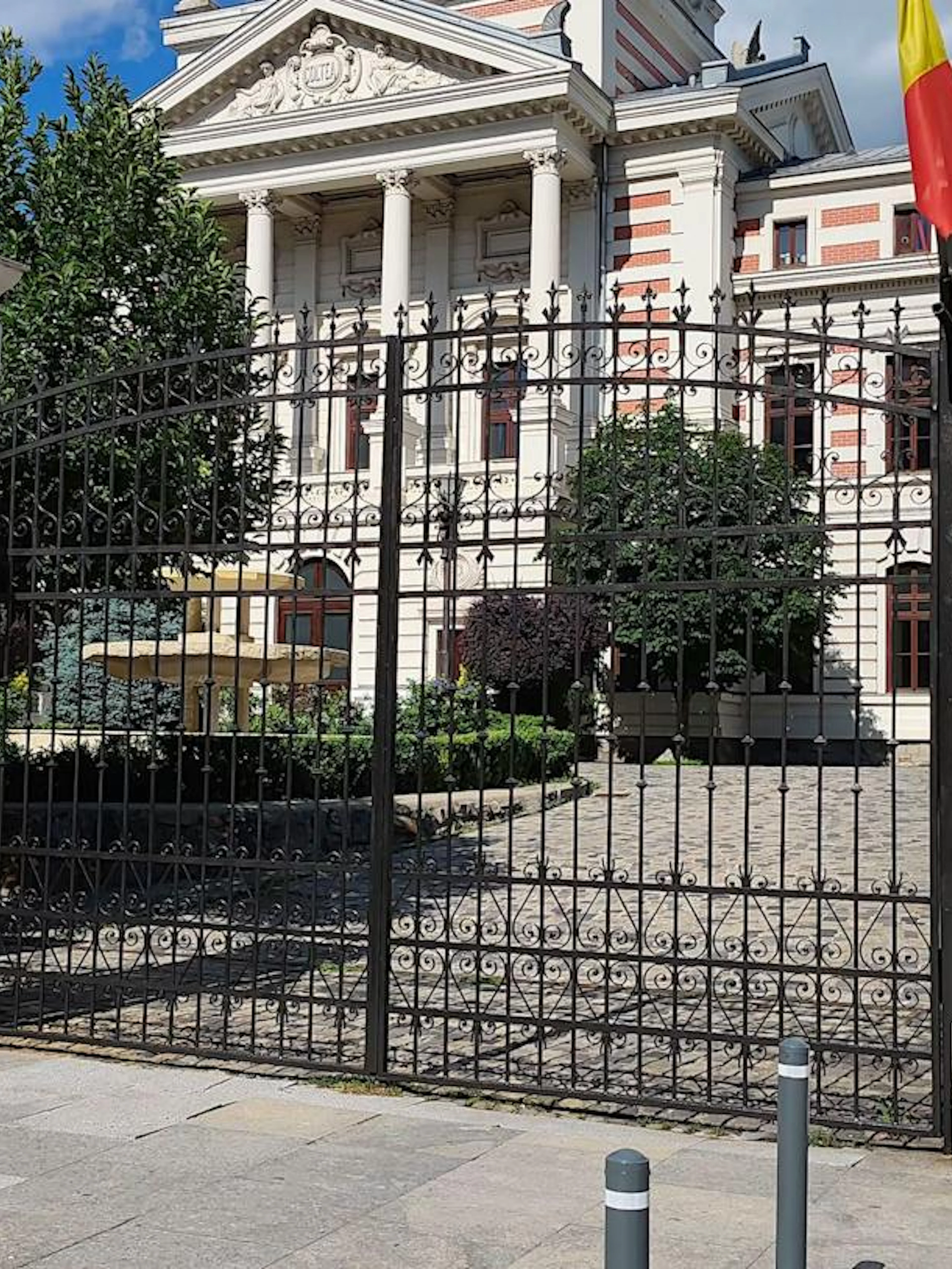 Wrought iron gate in front of Colțea Hospital, Bucharest, part of self-guided city exploration game.
