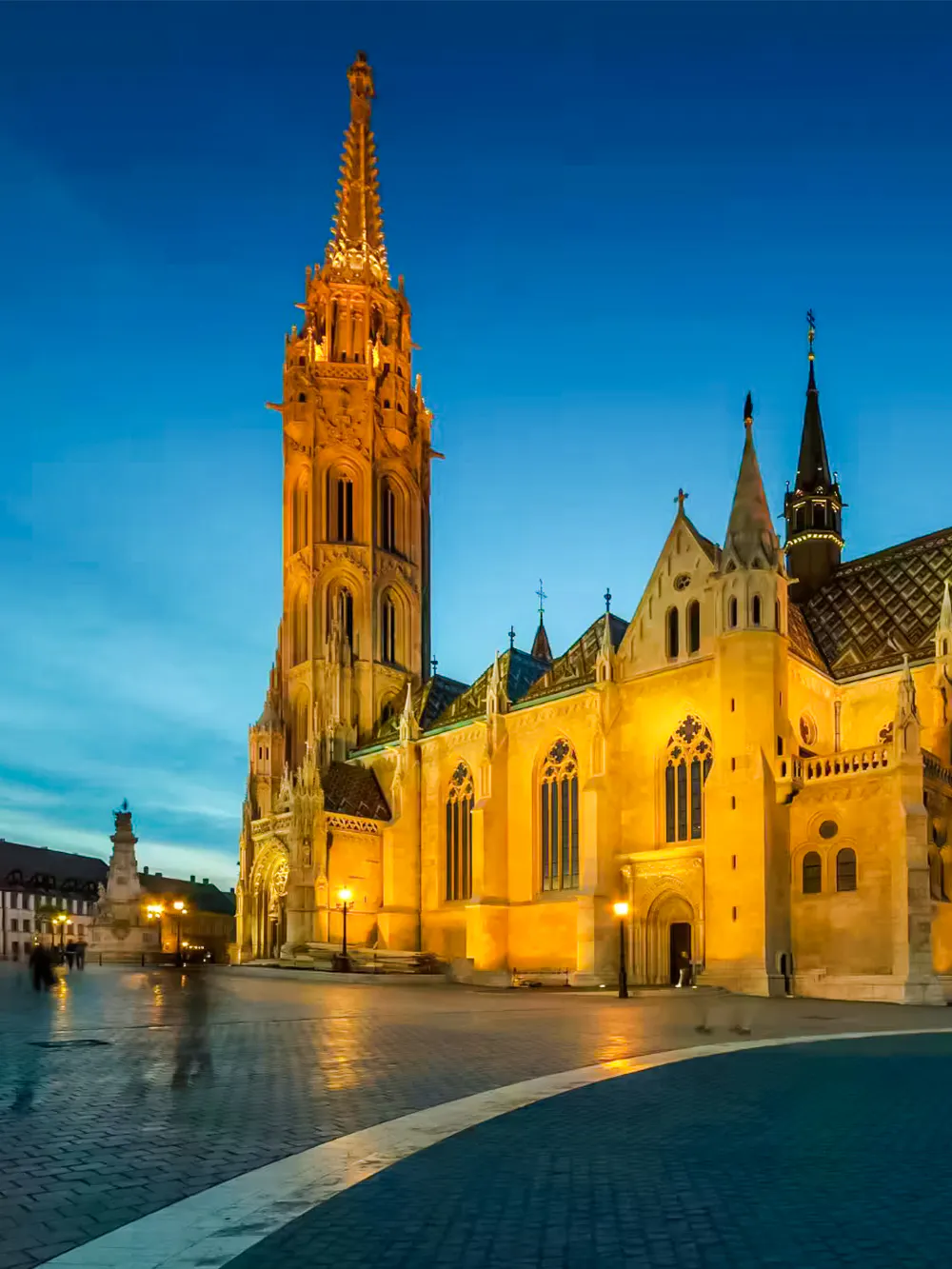 Matthias Church illuminated at dusk in Budapest, Hungary.