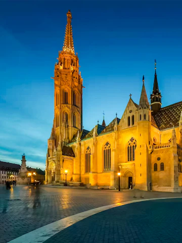 Matthias Church illuminated at dusk in Budapest, Hungary.