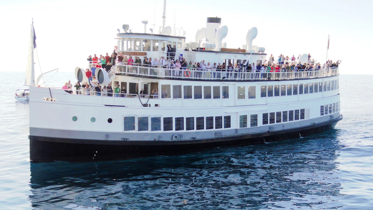 Large cruise ship with passengers on deck during San Francisco dinner cruise.