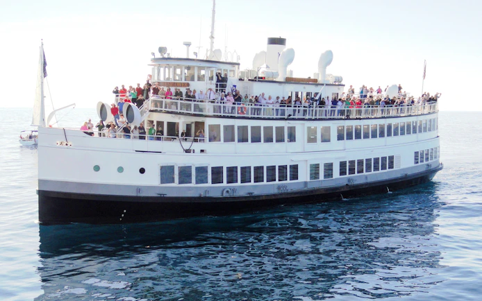 Large cruise ship with passengers on deck during San Francisco dinner cruise.