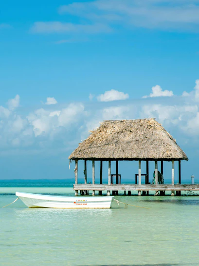Boat near a thatched-roof pier on Isla Holbox, Mexico.
