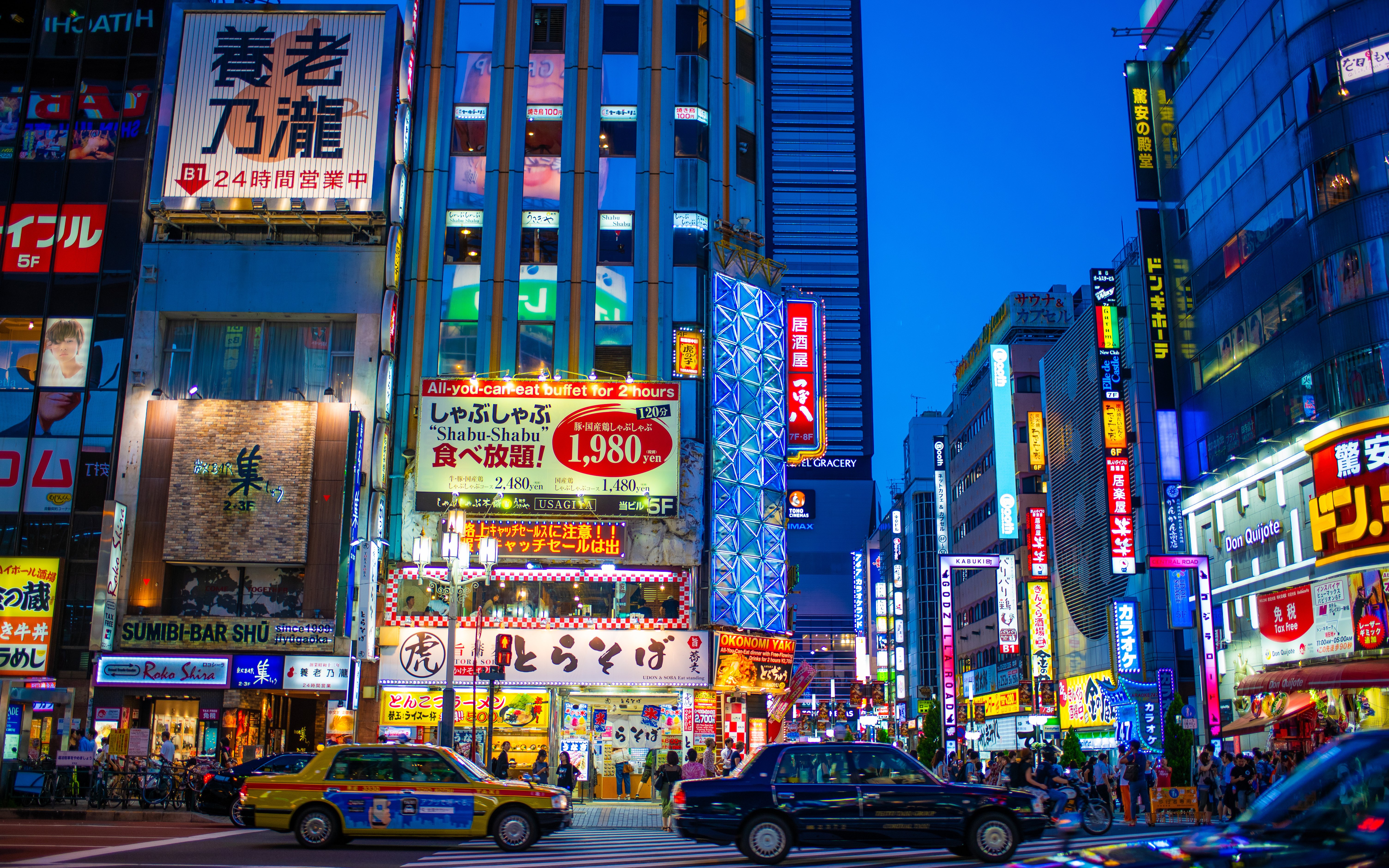 Neon-lit street in Shinjuku with bustling nightlife and colorful signs.