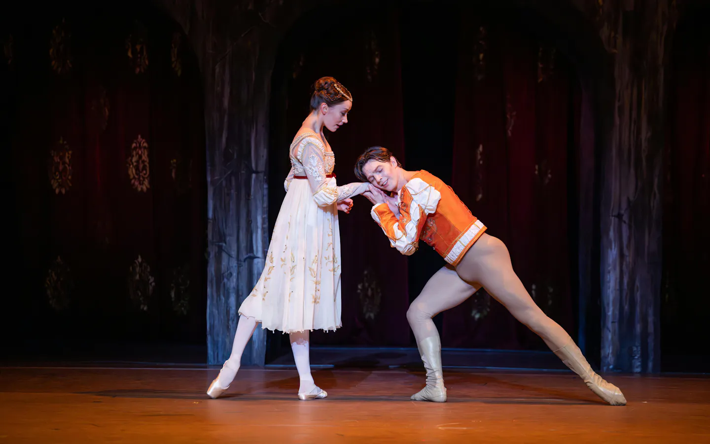 Australian Ballet dancers perform a scene from Romeo and Juliet on stage.