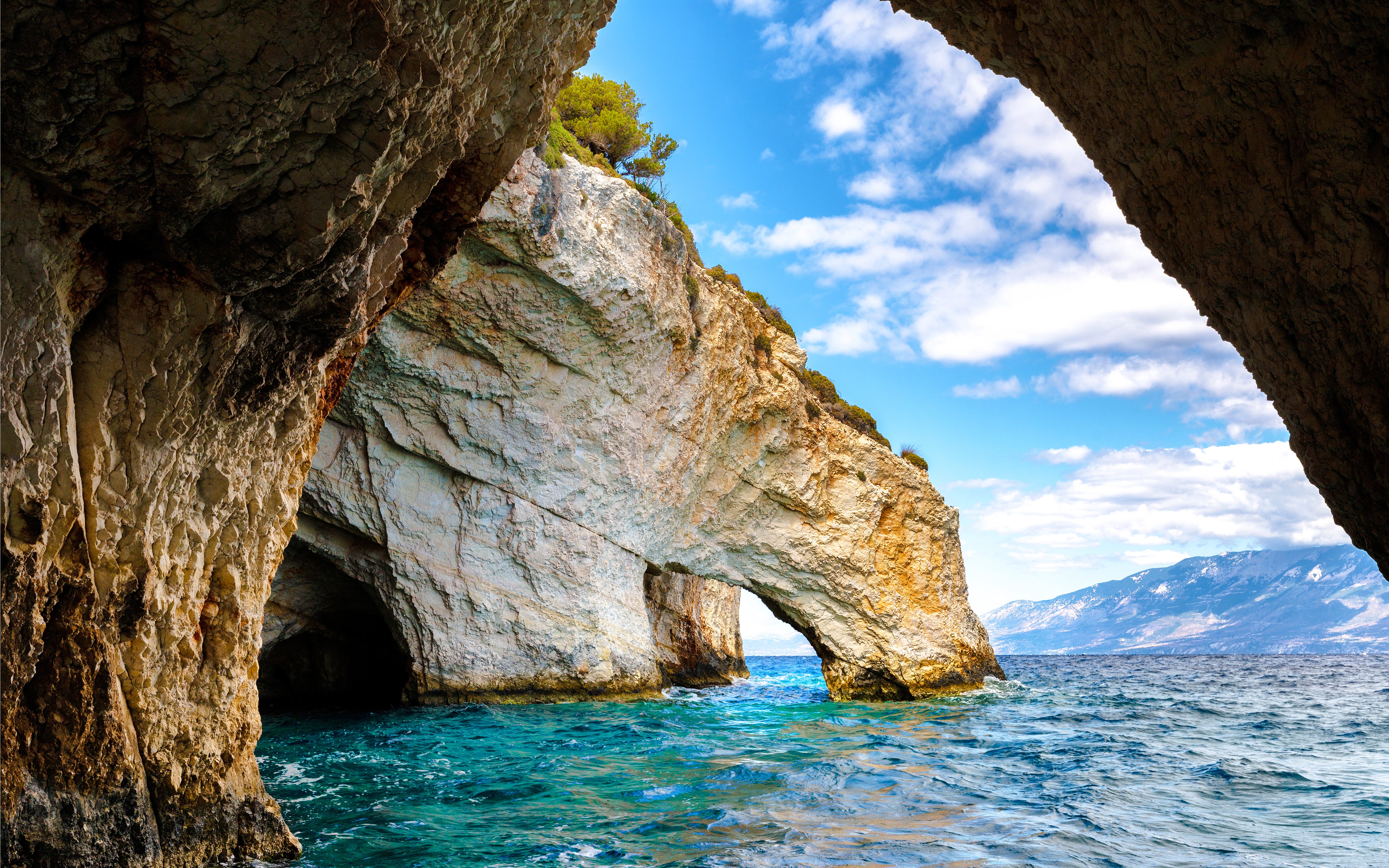 Blue caves with rocky arches and clear sea on Zakynthos island, Greece.