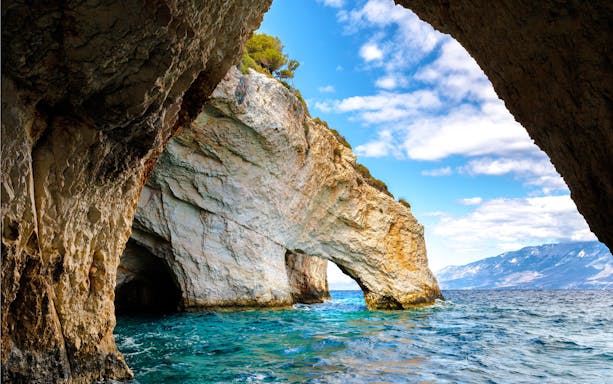 Blue caves with rocky arches and clear sea on Zakynthos island, Greece.