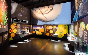 Miraikan permanent exhibition showcasing space exploration displays and interactive panels.