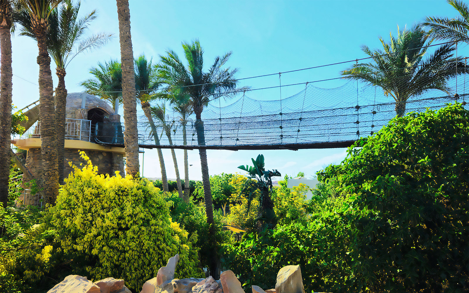 Rope bridge and lush greenery at Hurghada Grand Aquarium, Egypt.