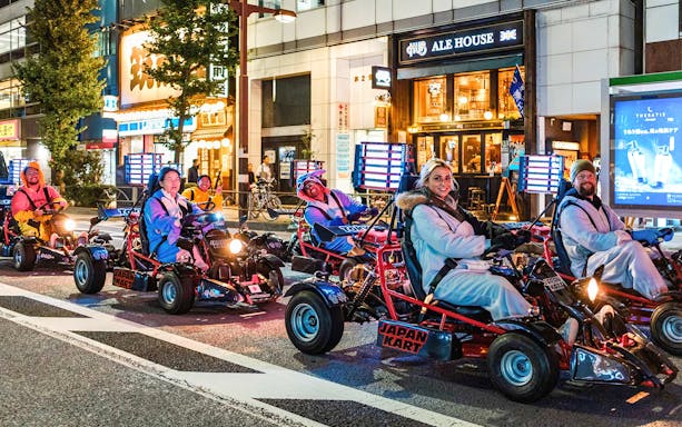 People enjoying a night go-kart ride on Asakusa Street, Tokyo.