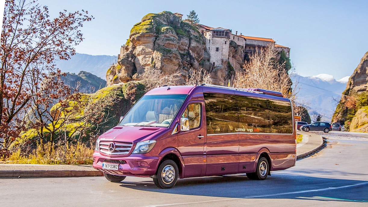 Tour bus in front of Meteora Monasteries, Greece, during a guided day trip from Athens.