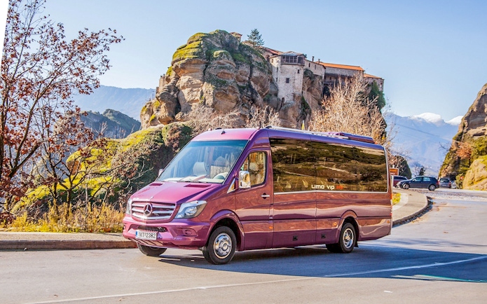 Tour bus in front of Meteora Monasteries, Greece, during a guided day trip from Athens.