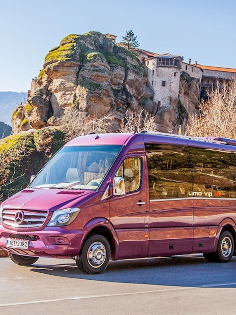 Tour bus in front of Meteora Monasteries, Greece, during a guided day trip from Athens.