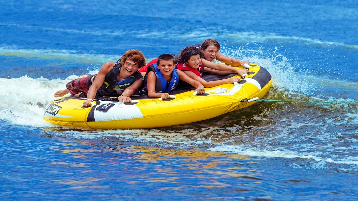 Group enjoying tube riding on water near Ile aux Cerf.