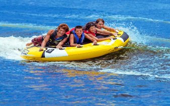 Group enjoying tube riding on water near Ile aux Cerf.