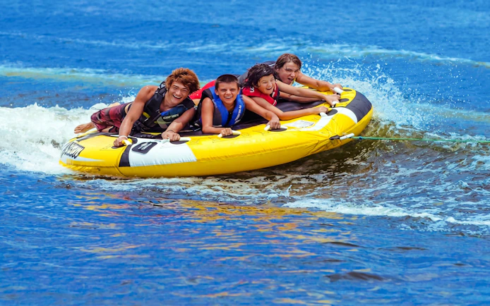 Group enjoying tube riding on water near Ile aux Cerf.