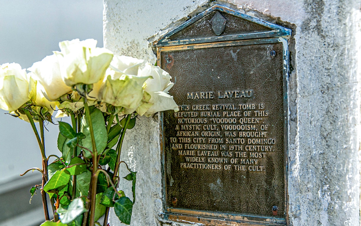 Tomb of Marie Laveau with white roses in St. Louis Cemetery, New Orleans.