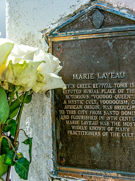 Tomb of Marie Laveau with white roses in St. Louis Cemetery, New Orleans.