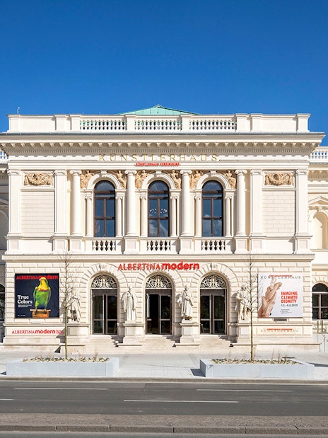 ALBERTINA MODERN museum entrance in Vienna with colorful art banners.