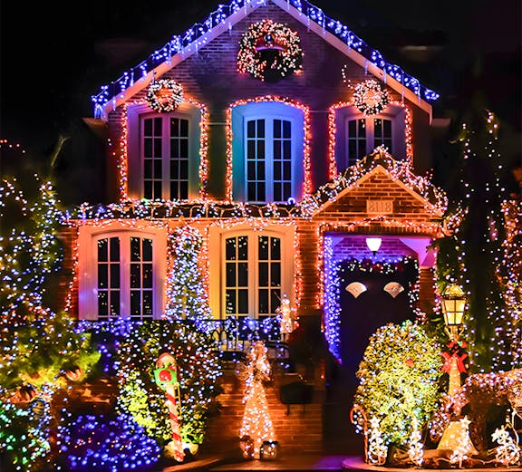 Holiday lights decorating a house in New York, featuring colorful displays and festive wreaths.