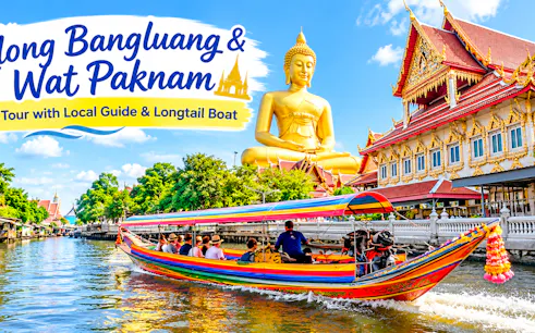 Longtail boat on canal near Wat Paknam temple with large Buddha statue, Bangkok tour.