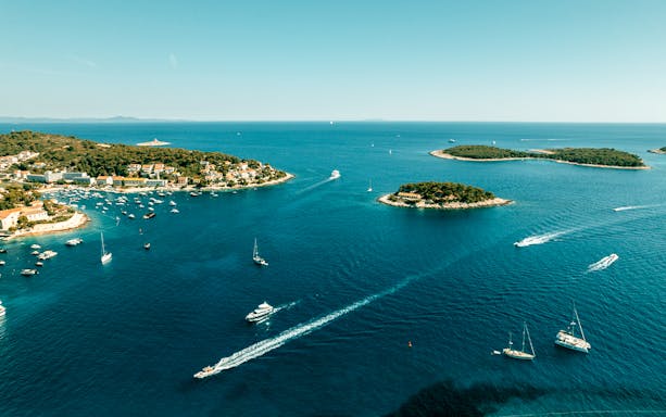 Aerial view of Pakleni Islands, Croatia, showcasing lush greenery and turquoise waters.