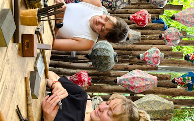 Creating jewelry at a workshop in Hoi An, surrounded by colorful lanterns.