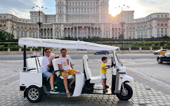 Tuk Tuk tour in front of the Palace of the Parliament, Bucharest.
