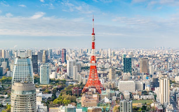 Tokyo Tower amidst city skyline in Tokyo, Japan.