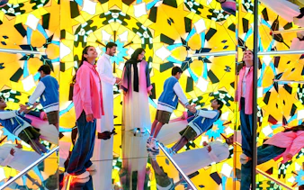 Visitors exploring mirrored kaleidoscope room at House of Hype.